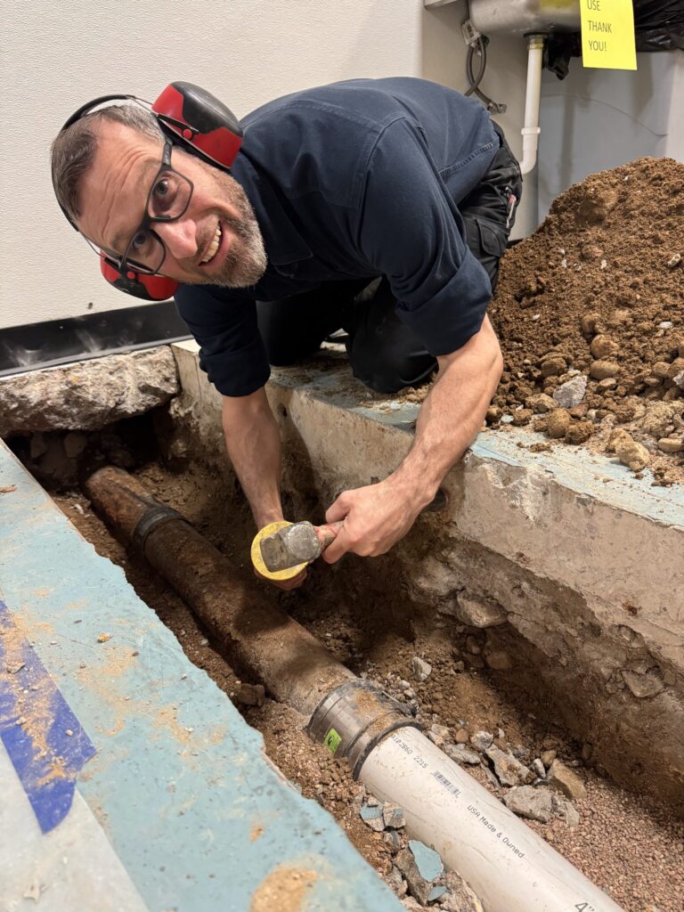 Main sewer line cleaning service clearing blockage at outdoor cleanout access point