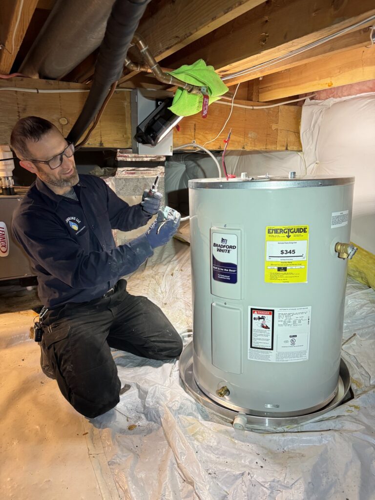 Emergency water heater repair service fixing tank in a crawl space during 24-hour service call